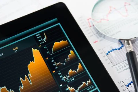 Touching screen of tablet pc with market graph Stock Photos