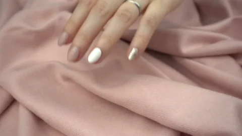 Touching sensitive fabric in slow motion. Woman's hand softly strokes a textile. Stock Footage 120029989