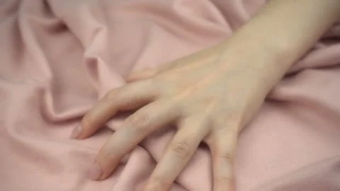 Touching sensitive fabric in slow motion. Woman's hand softly strokes a textile Stock Footage 120030130
