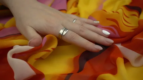 Touching sensitive multicolored fabric in slow motion. Woman's hand softly strok Stock Footage 120127718