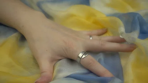Touching sensitive multicolored fabric in slow motion. Woman's hand softly strok Stock Footage 120190419
