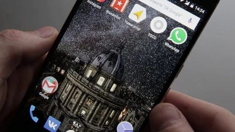 Touching a smartphone with a touch screen to scroll on calendar application Stock Footage 70141138