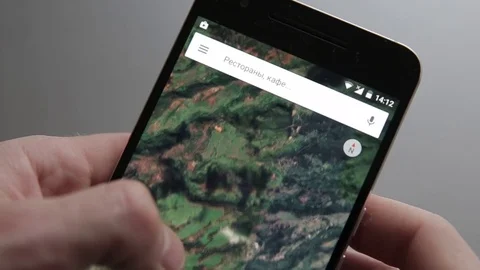 Touching a smartphone with a touch screen to scroll on google maps Stock Footage 70141160
