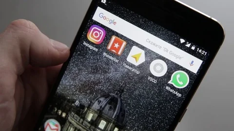 Touching a smartphone with a touch screen to scroll on instagram application Stock Footage 70141176