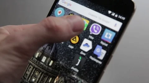 Touching a smartphone with a touch screen to tern on navigation aplication Stock Footage 70141258