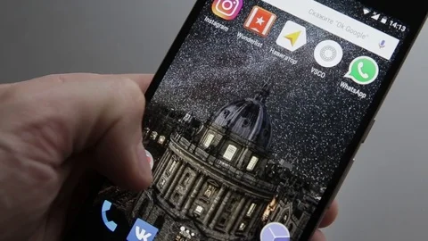 Touching a smartphone with a touch screen to tern on of gmail application Stock Footage 70141350