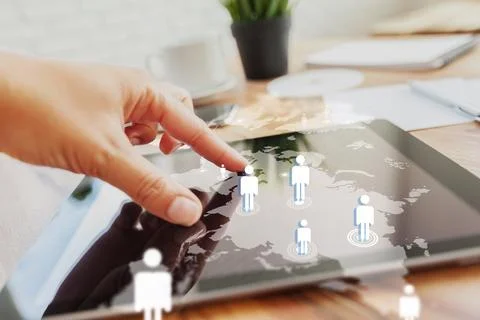 Touching a tablet screen showing customer relationship management data in an Stock Photos