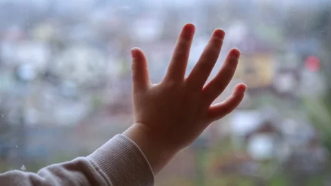 Touching window The hand of a 5-year-old child touches the window Stock Footage 293095011