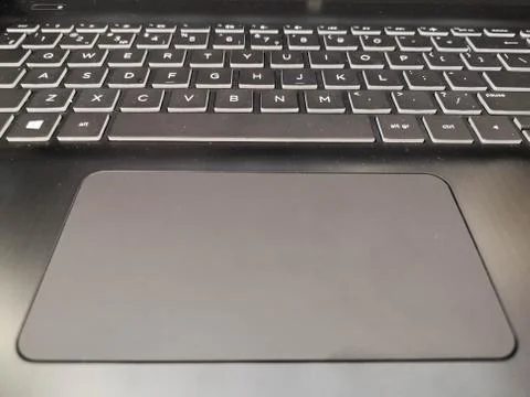 Touchpad in a laptop, large, comfortable touchpad. Close up hands of unrecogn Stockfoto's