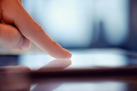 Touchscreen digital tablet finger macro Stock Photos