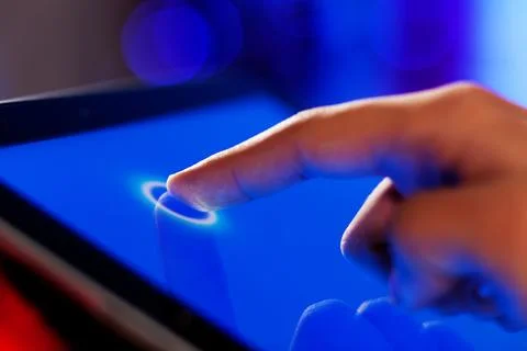 Touchscreen Finger Tap on Blue Digital Tablet Interface Stock Photos