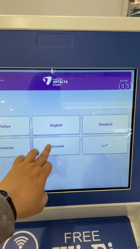 Touchscreen language selection at Antalya Airport terminal, featuring multi.. Stock Footage 331216039