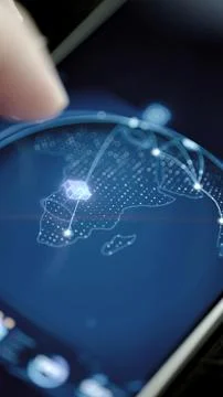 Touchscreen map centers purple cube over Africa Stock Photos