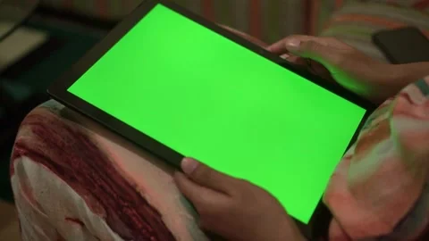 Touchscreen tablet with green display held by hand. Stock Footage 327614291