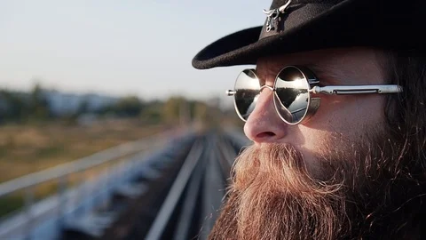 The tough guy stands on the edge of the bridge and looks towards the sunset. Stock Footage 108959105
