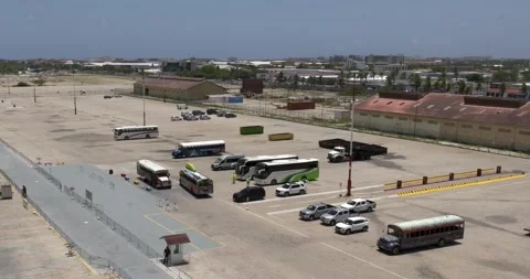 Tour and excursion busses line up at Port of Oranjestad in Aruba Stock Footage 318271619