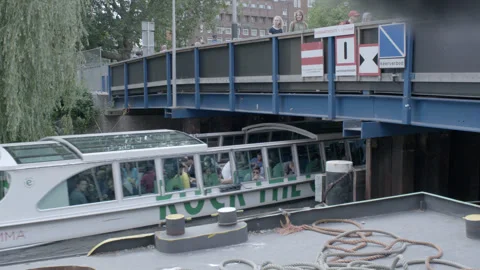 Tour Boat Navigating Under Low Bridge on Canal Stock Footage 344603272