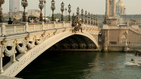 Tour boat passing under Alexandre III bridge at golden hour in Paris Stock Footage 113188380