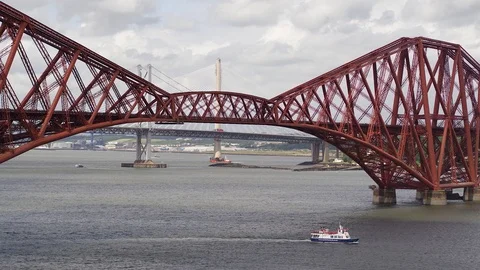 Tour boat passing under the Forth Bridge Stock Footage 99999241