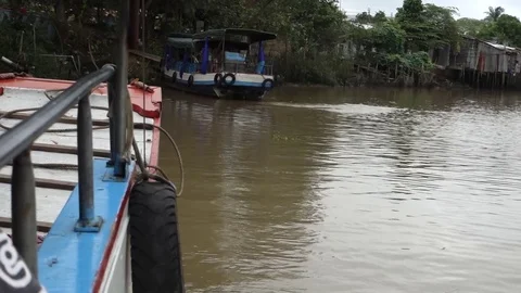 Tour boat pulling away from dock on Mekong River Vietnam Stock Footage 83098480