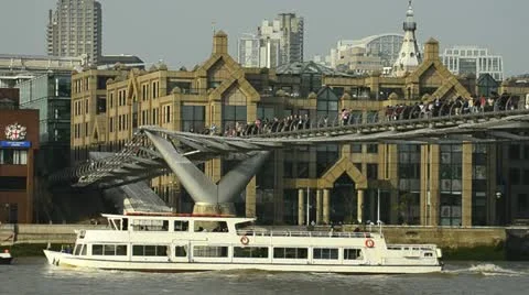 Tour boat under millenium bridge, London Stock Footage 10887232