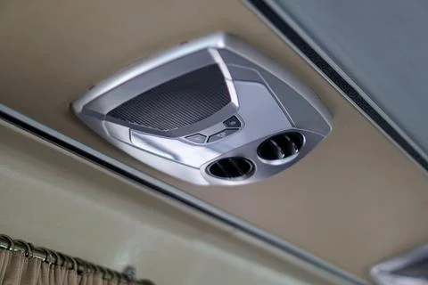 A tour bus ceiling control console equipped with AC vents, reading light buttons Stock Photos