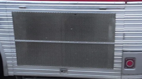 Tour bus riding down road wheel shot far away shot Stock Footage 33890155