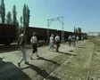 Tour group walking along train track SD Footage