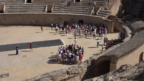 Tour groups and guides in El Jem Amphitheatre, history and tourism Tunisia Stock Footage 345037132