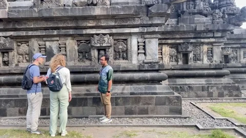Tour Guide Explaining Prambanan Temple History to Visitors Stock-Footage 336310609