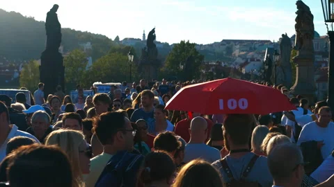 Tour guide holding red umbrella walking tourists charles bridge prague Stock Footage 301429430