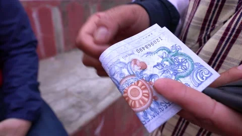 Tour guide talking about Bhutan money Ngultrum with tourist in Thimphu, Bhuta Stock Footage 236002591