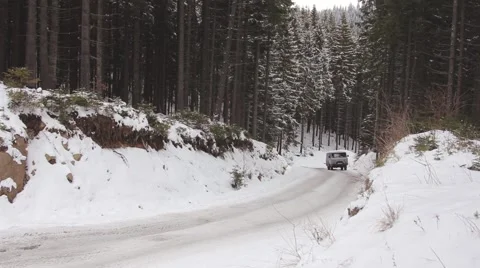 Touring on snow-covered mountain roads in a four-wheel drive car Stock Footage 59159098
