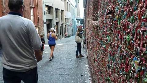 Tourist Adds to Gum Wall Seattle Stock Footage