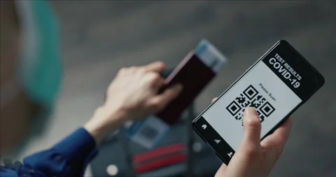 Tourist in airport using mobile app in phone to show covid-19 test results for Stock Footage 146402653