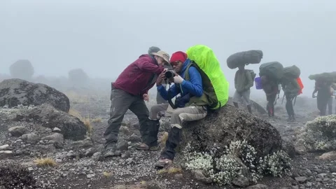 Tourist asks his black guide to take a picture of him with his camera Stock-Footage 168861327