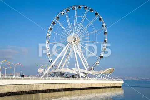 Tourist attraction - a ferris wheel on the shore of the Caspian Sea. Baku Stock Photos