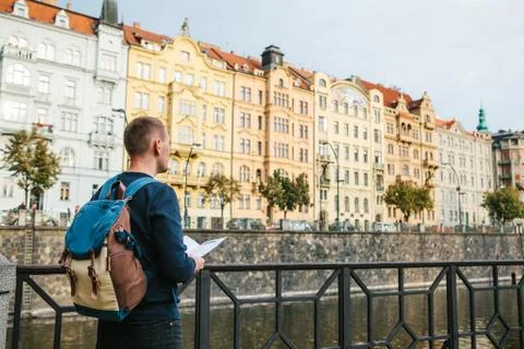 A tourist with a backpack on the backdrop of the old architecture in Prague in Stock Photos