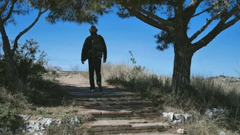 Tourist with a backpack climbs a hill Stock Footage 156301435