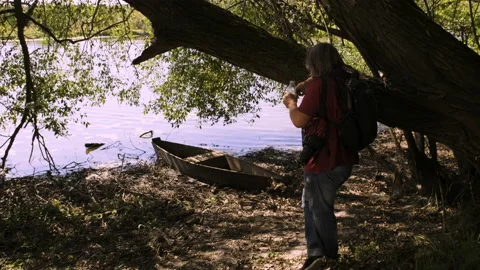A tourist with a backpack drinks water from a bottle chick Stock Footage 147076015