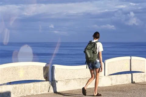 A tourist with a backpack on her back Stock Photos