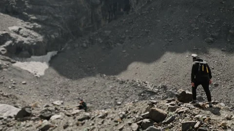 A tourist with a backpack on his back walks along a mountain path. Stock Footage 281262284