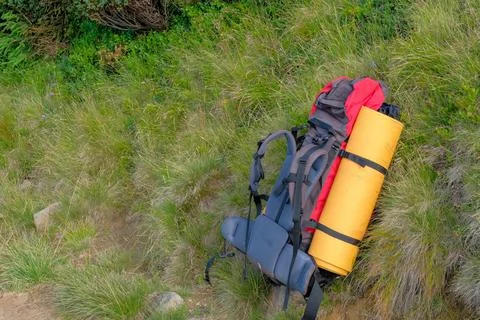 Tourist backpack in the mountains. Stock Photos