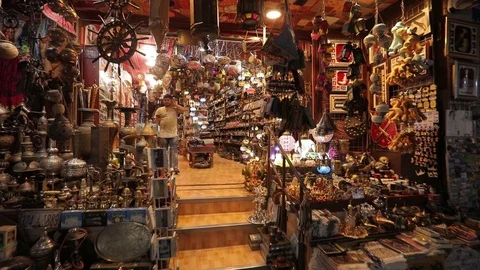 Tourist with a backpack in a small oriental store, chooses souvenirs . Stock Footage 119238033