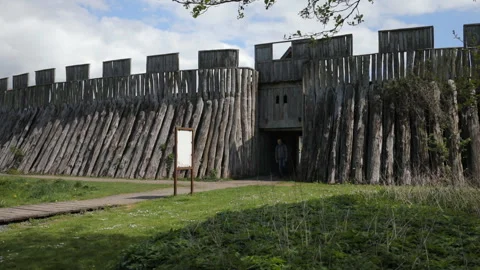 Tourist with backpack visiting viking ring fortress Trelleborgen in Trelleborg, Stock Footage 129654055