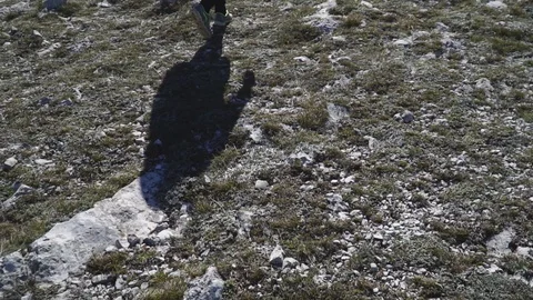 Tourist with backpack walking high in the mountains above sea Stock-Footage 104338830