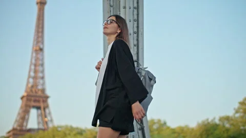 Tourist with backpack walking near Eiffel Tower exploring Paris Stock Footage 315287370