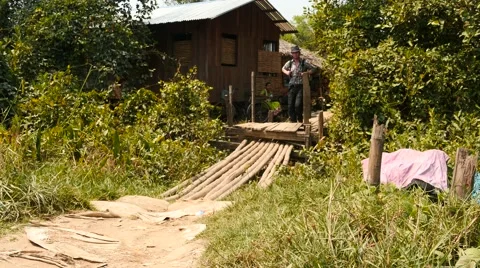 Tourist backpacker on a small bridge in Myanmar village Stock Footage 61404429