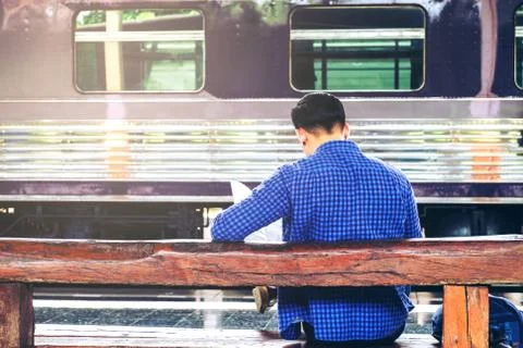 Tourist backpacker using map to travel at train station Stock Photos