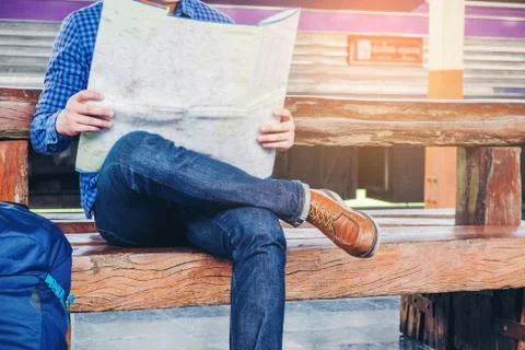Tourist backpacker using map to travel at train station Stock Photos